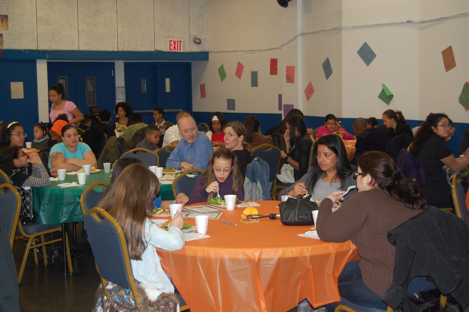 Mentees, mentors and families at a BOOM community dinner funded by donations.